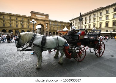 Florence, Sept 2019: carriage with white horses in Piazza della Repubblica in the center of Florence, Italy