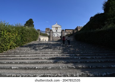 Florence, September 2021: Tourists on the step in front of the facade of the famous Basilica of San Miniato in Florence.