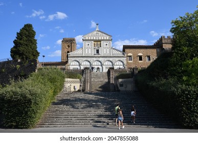 Florence, September 2021: Tourists on the step in front of the facade of the famous Basilica of San Miniato in Florence.
