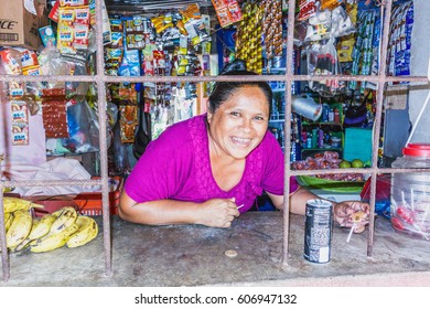 Flores, Guatemala - December 14, 2016: Woman Selling Goods In A Corner Store In Small Village Near Flores, Guatemala.