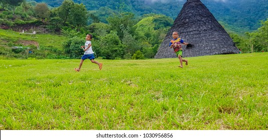 FLORES, INDONESIA - DECEMBER 14, 2017: Little Children Running Around At Wae Rebo Village. Wae Rebo Is The Famous Manggarai's Traditional Villages, Consist Of 7 Custom House Named As Mbaru Niang