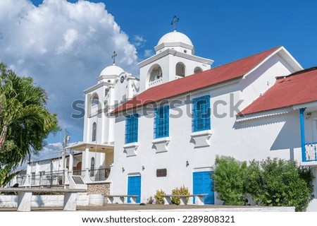 Flores island Guatemala Church with its whitewashed facade and blue doors and windows located in the main square of Flores island