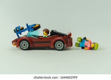 Florianopolis - Brazil, February 2, 2020: Minifigure  Of Cyclist Getting Hit By Sportive Car. Traffic Accident With Injured Biker On The Ground. Minifigures Are Manufactured By The Lego Group.