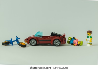 Florianopolis - Brazil, February 2, 2020: Minifigure  Of Cyclist Getting Hit By Sportive Car. Traffic Accident With Injured Biker On The Ground. Minifigures Are Manufactured By The Lego Group.