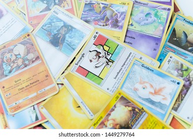 Florianopolis - Brazil, July 12, 2019: Pokemon Cards Distributed On The White Table. Brazilian Youths Perform Battles Using These Collectible Cards