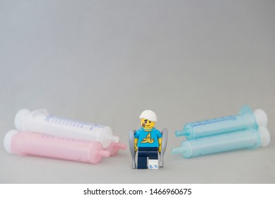 Florianopolis - Brazil, July 31, 2019: Closeup Clumsy Guy Wih His Crutches Between Syringes On White Background. Minifigures Are Manufactured By The Lego Group.