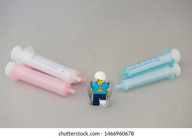 Florianopolis - Brazil, July 31, 2019: Closeup Clumsy Guy Wih His Crutches Between Syringes On White Background. Minifigures Are Manufactured By The Lego Group.