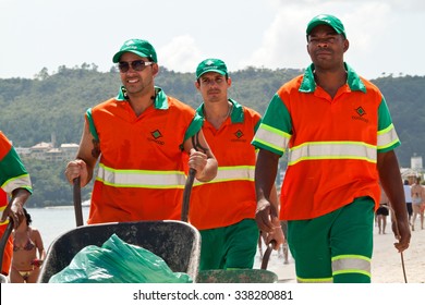 Florianopolis, SC, Brazil - Feb 5, 2012: Street-sweeper team taking care to keep the beach cleaned. The Comcap is the company hired by the city hall to execute the public cleaning service.
