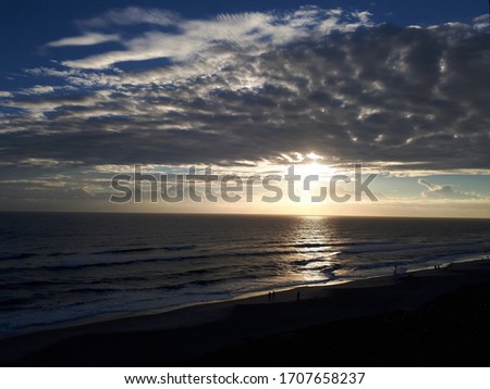 Florida beach with sun behing clouds