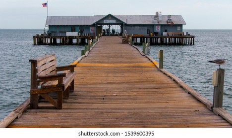 Florida, Island Anna Maria - November 28, 2011: Wooden Pier Going To The Ocean With A House At The End. Florida