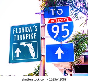 Florida Turnpike Green Metal Sign Next To Interstate 95 Blue And Red Sign On A Metal Post.