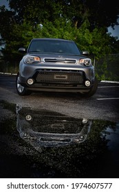 Florida, Year 2019: Front View Of A Kia Soul, Reflection In Water. Korean Car.  Gray Body.