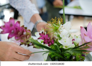 Florist Arranging Flower Bouquet In Vase. People In Floristry Class Course Workshop