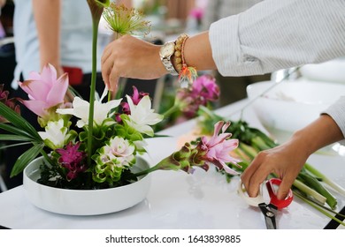 Florist Arranging Flower Bouquet In Vase. People In Floristry Class Course Workshop