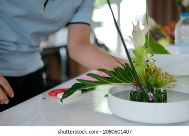 Florist Arranging Flower Bouquet In Vase. People In Floristry Class Course Workshop