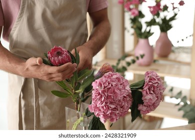 Florist with beautiful flowers in workshop, closeup - Powered by Shutterstock