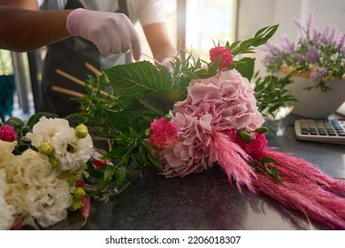 Florist creates a bouquet of flowers on the table - Shutterstock ID 2206018307