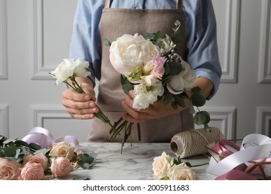 Florist creating beautiful bouquet at white marble table, closeup - Shutterstock ID 2005911683