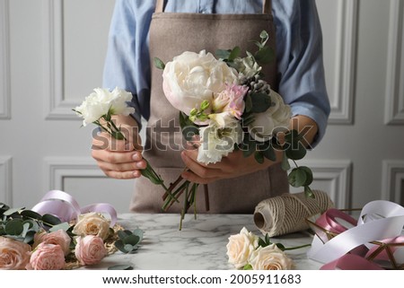 Image, Stock Photo Woman prepares a bouquet of red roses