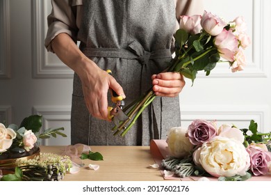 Florist Cutting Flower Stems With Pruner At Workplace, Closeup