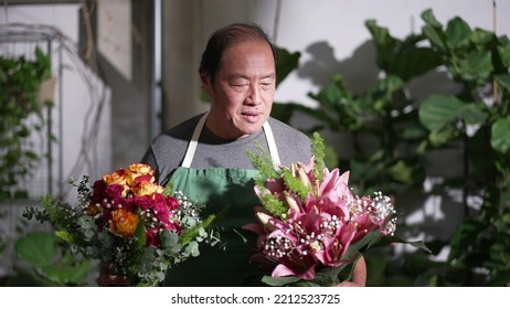 Florist Entrepreneur Holding Bouquet Of Flower Arrangement Ready For Customer Delivery. Portrait Of An Asian Middle Age Small Business Owner