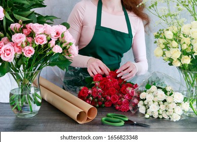 Florist in flower shop shows colorful roses to the clients.  - Powered by Shutterstock