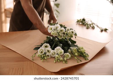 Florist making beautiful bouquet in workshop, closeup - Powered by Shutterstock