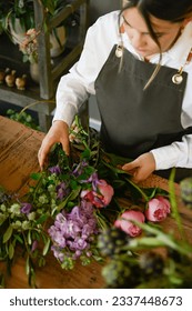 Florist making bouquet of flowers at workplace