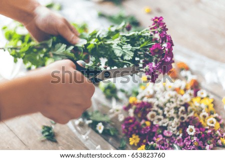 Similar – Hands make bouquet in vase