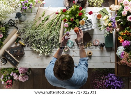 Similar – Woman makes wildflower bouquet in vase on the table