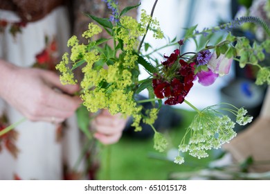 Florist making a post out of assorted flowers