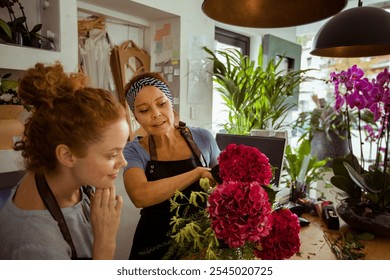 Florist mother and daughter working together at the flower shop - Powered by Shutterstock