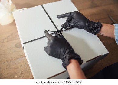 Florist Using A Black Grosgrain Ribbon For Gift Wrapping