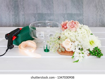 Florist At Work. How To Make Floral Decorations On Summer Party Table. Centerpiece With Rose, Dahlia And Hortensia Flowers. White Plates, Table Cloth, Romantic Wedding Reception. Step By Step, Diy. 