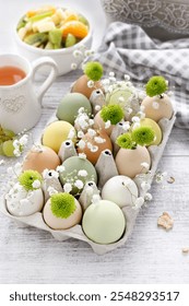 Florist at work: How to make simple easter floral arrangement with ordinary paper egg box, chrysanthemum santini flowers, gypsophila paniculata twigs and moss. Step by step, tutorial.
