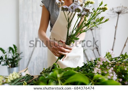 Similar – Hands make bouquet in vase