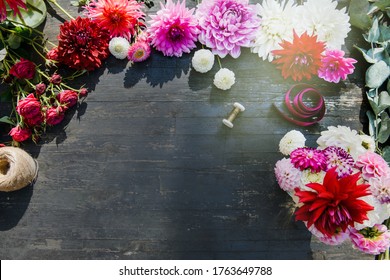 The florist work table with tools on dark wooden background. copy space