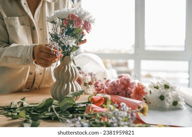 Florist at work. Woman making autumn floral decorations. - Powered by Shutterstock