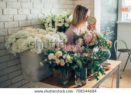 Similar – Woman with peonies on table in the living room