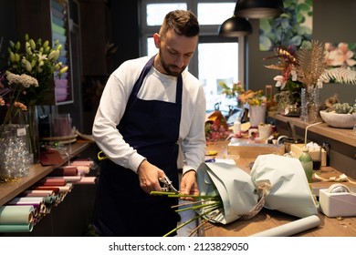 Florist At Workplace Cutting Fresh Flowers