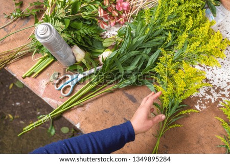 Florist worktable. Florist at work creating bouquet at flower shop. top view .
