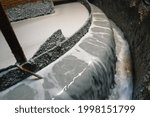 Flotation machine. A stream of gray, dirty liquid flows down from the separating edge of the bath.