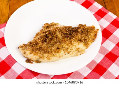 Flounder Fillet Breaded In Parmesan Cheese On Old Table With Red Plaid Tablecloth