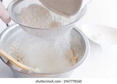 Flour Being Sifted Through A Fine Mesh To Break Big Particles And Lumps, This Helps The Aeration Process And Optimizes The Flour To Bake With It.
