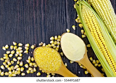 Flour and grits corn  in spoons, cobs and grains maize on a background of dark wooden boards