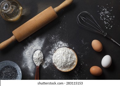 Flour And Ingredients On Black Table. Top View