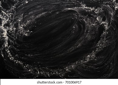 Flour on black, baking background with copy space