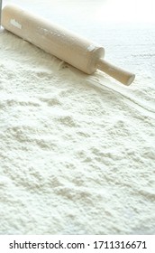 Flour and rolling pin on the table.