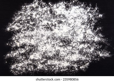 flour sprinkled on a dark table background