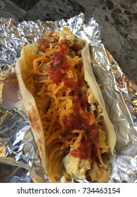 Flour Tortilla BreakFast Taco With Scrambled Eggs And Bacon And Potatoes  On Foil 